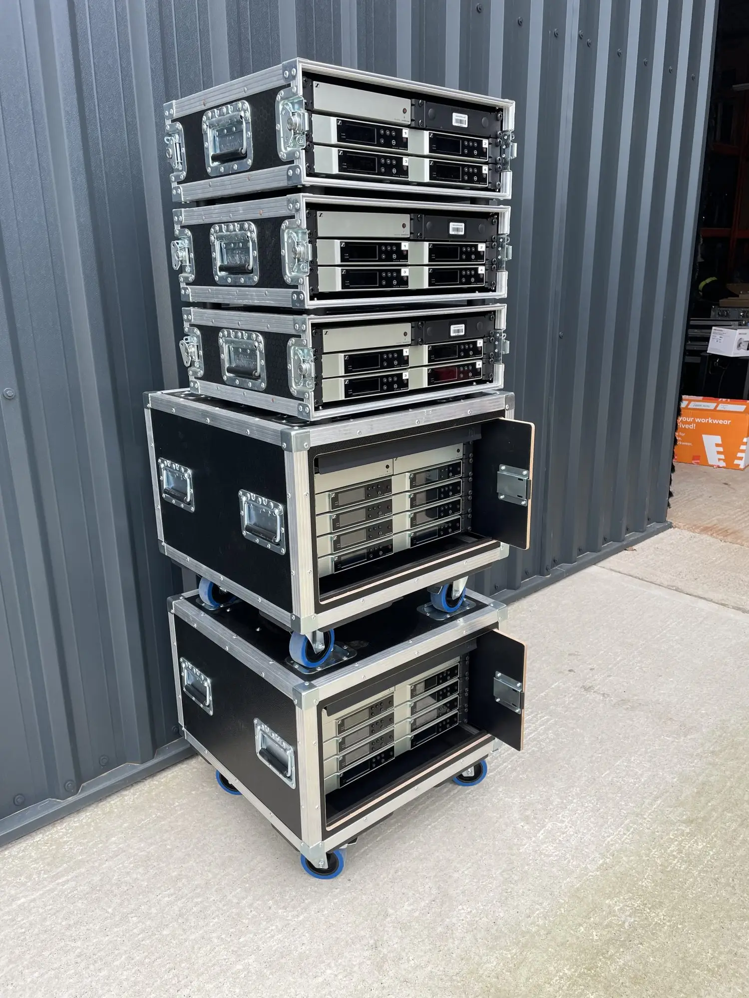 Racks holding 28 channels of Sennheiser wireless microphones ready for hire