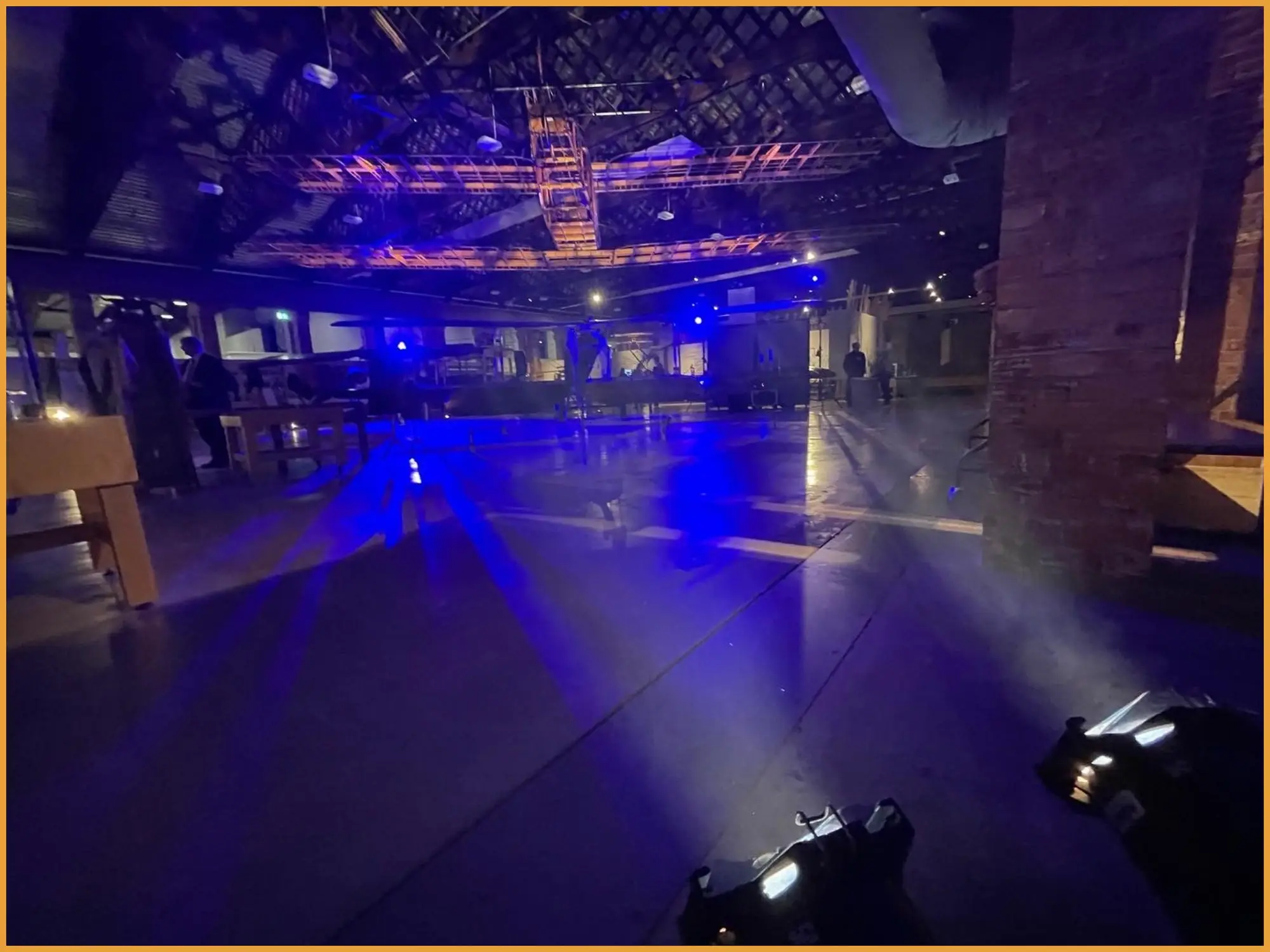Beams of blue light across the hangar floor