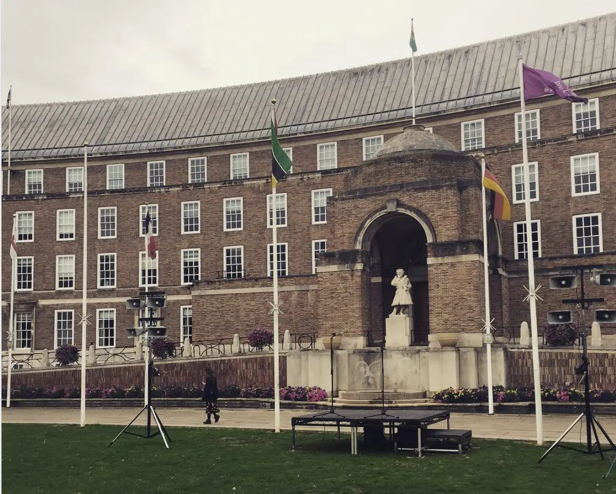 Small stage and speakers set up on College Green in front of Bristol City Hall