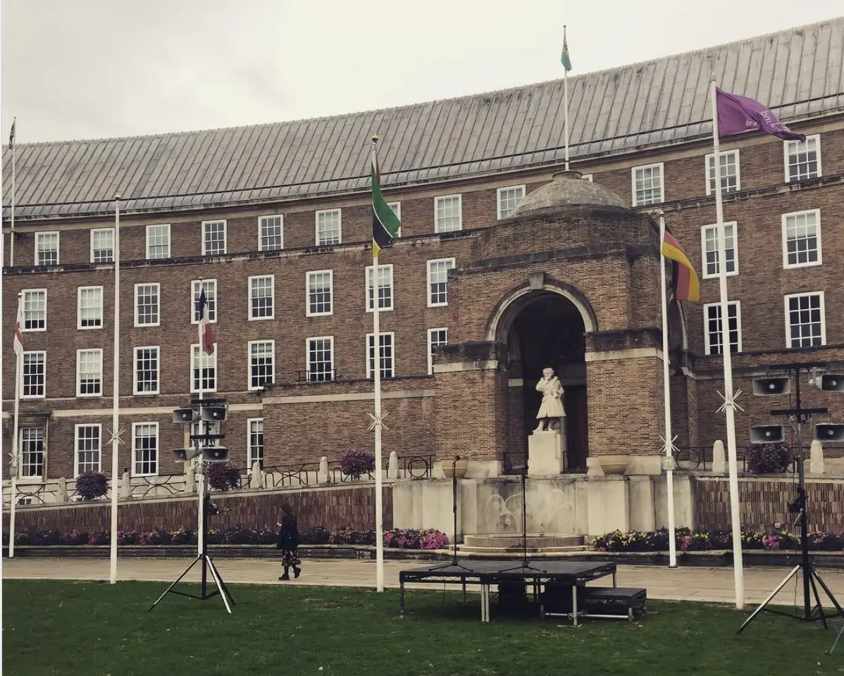 Small stage and speakers set up on College Green in front of Bristol City Hall