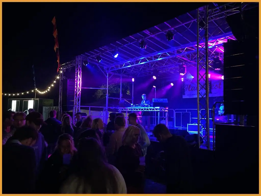 Guests dancing in front of the stage at night