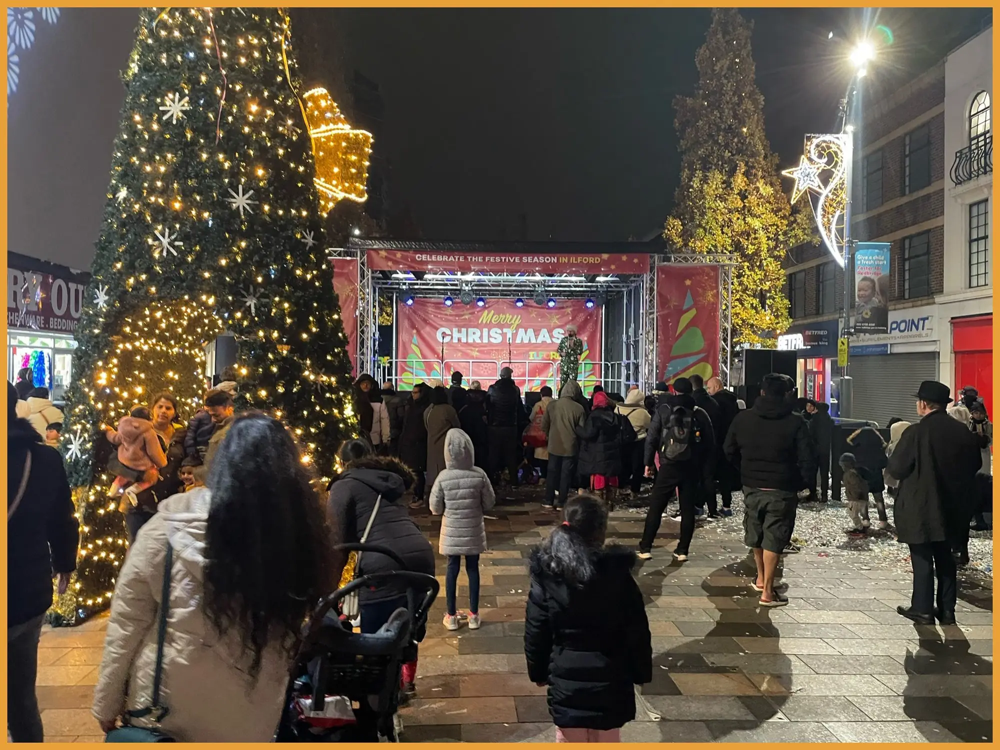 Families watching the concert beside the Christmas tree