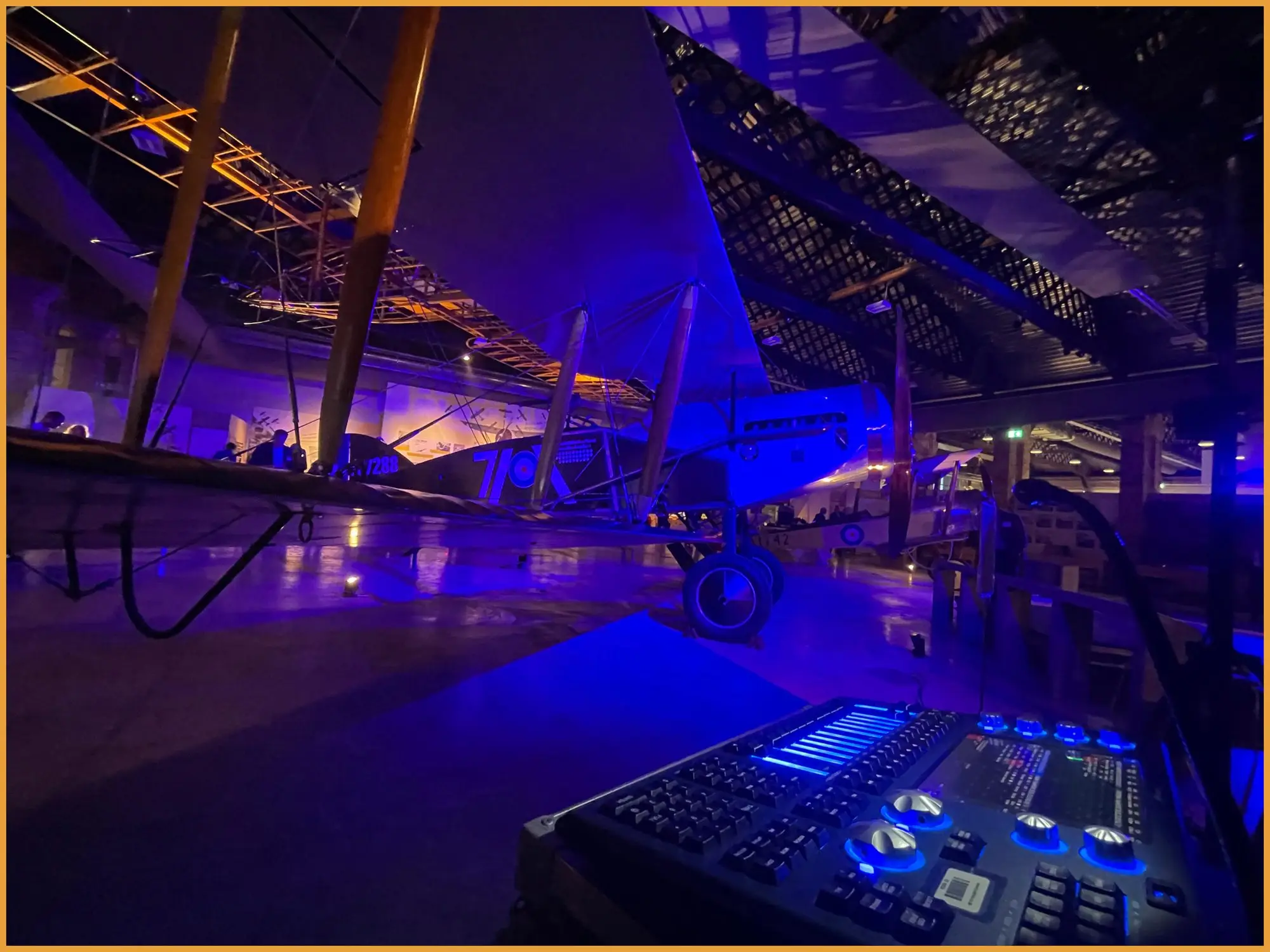 Lighting desk in the foreground with the lit aircraft behind