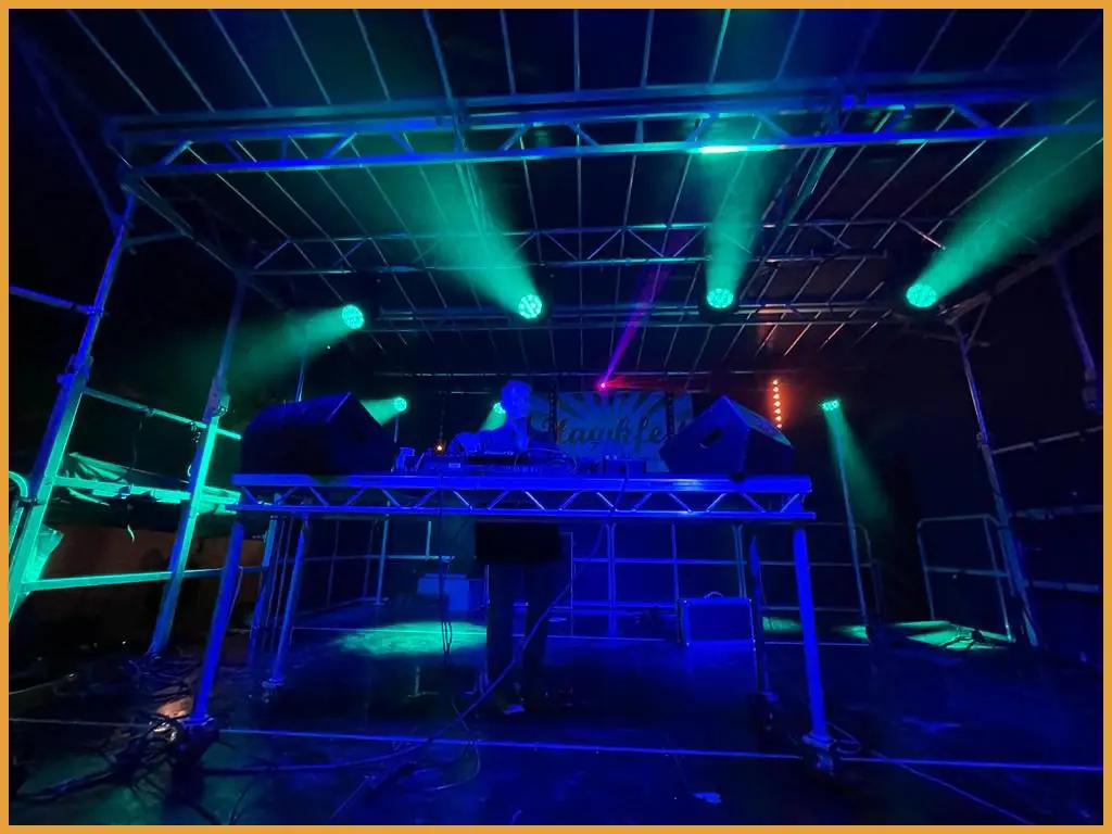 DJ closing the night on the stage lit in blue