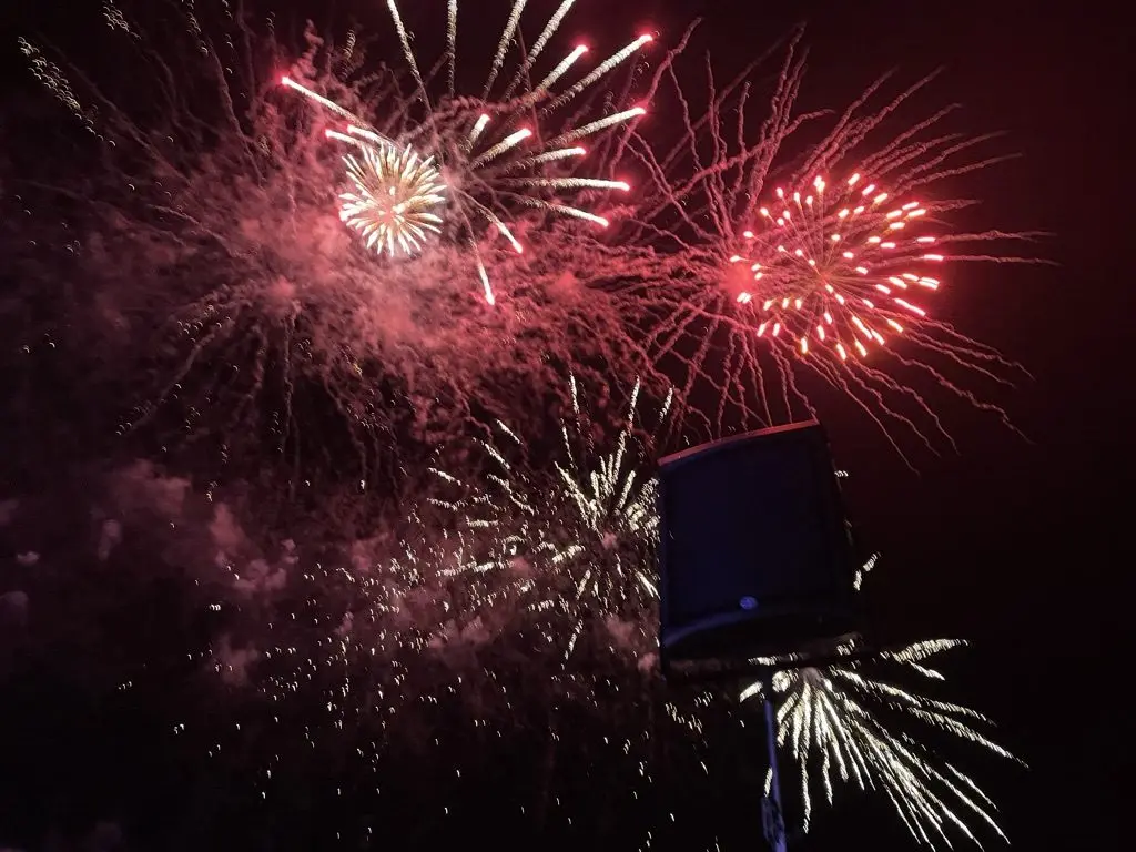 New Year fireworks bursting above a loudspeaker