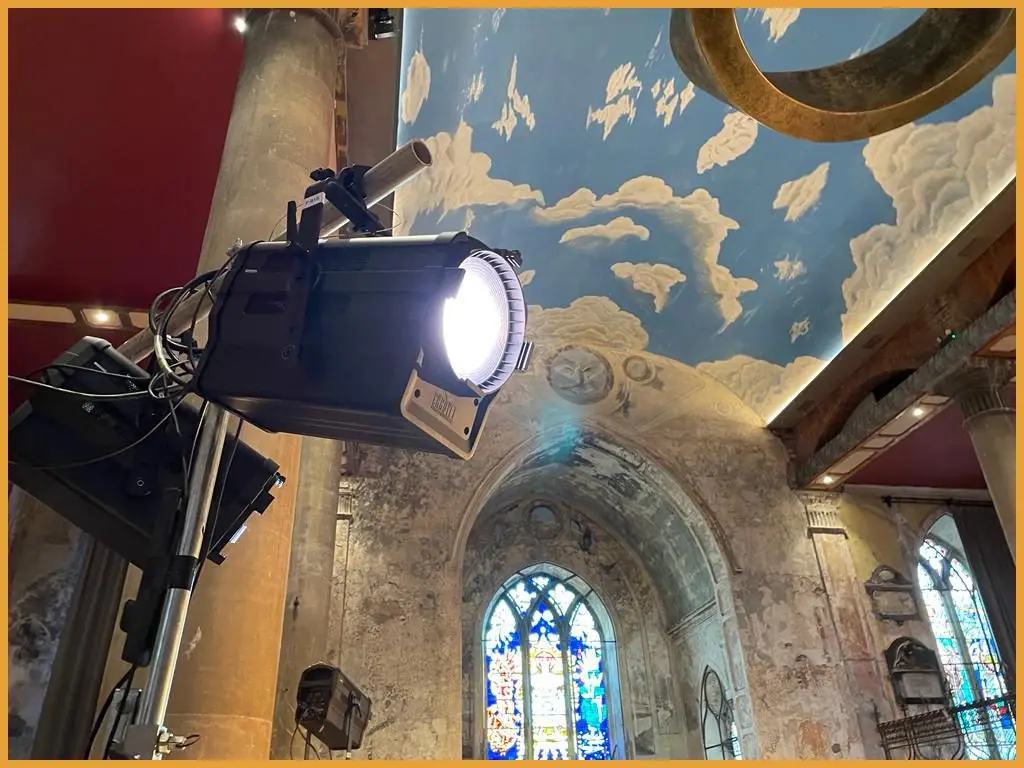 Lighting fixture positioned below the venue's stained glass window