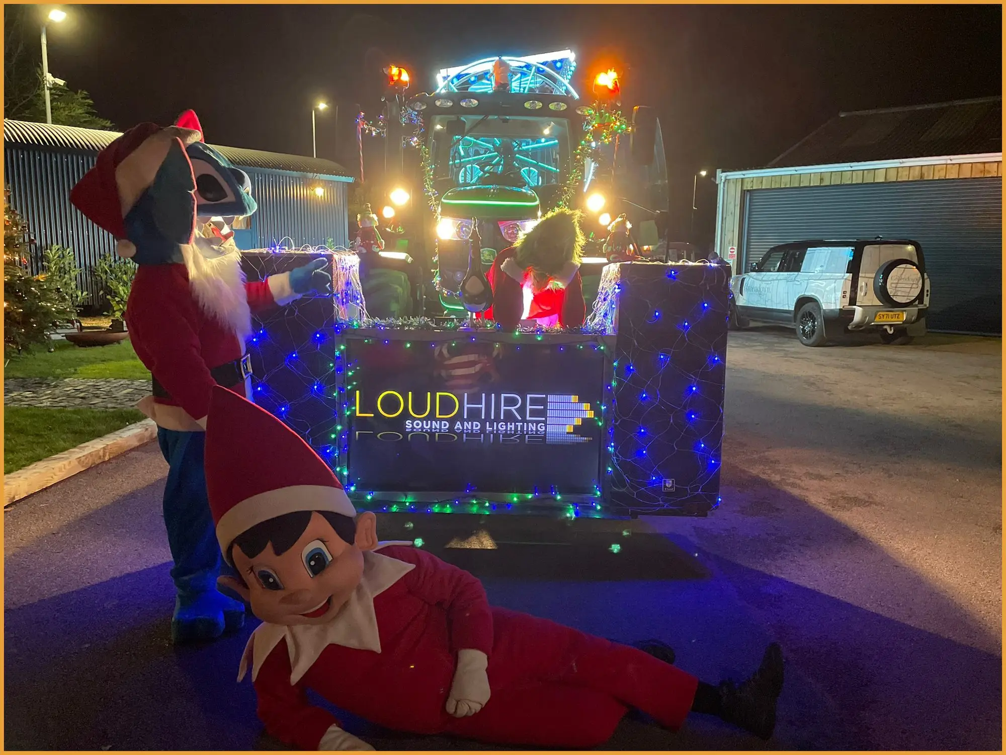 Illuminated Santa's float on a trailer at night