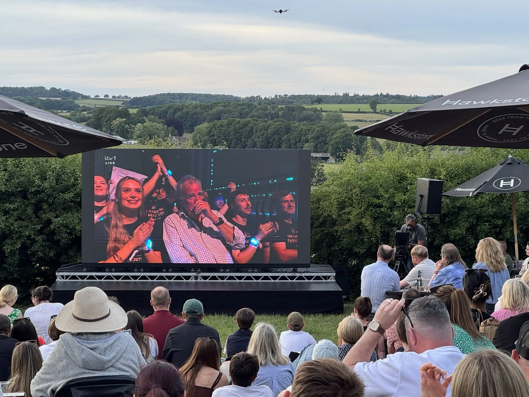 Audience watching a live television broadcast on an outdoor LED video wall at The Farmer's Dog