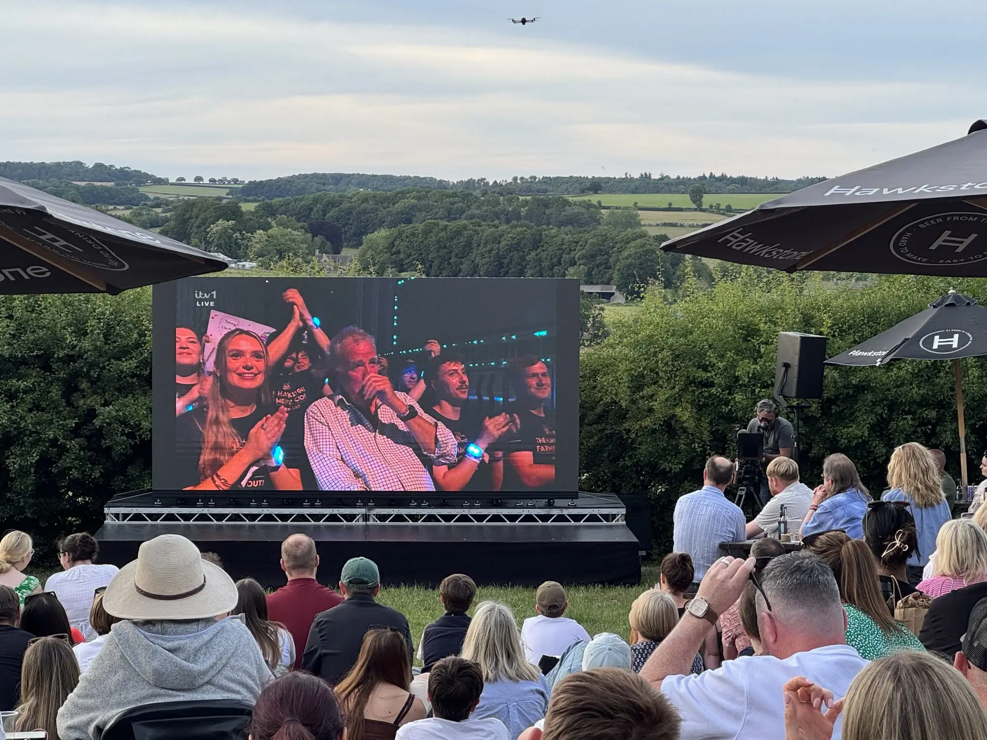 Crowd watching a live broadcast on an outdoor LED wall at The Farmer's Dog