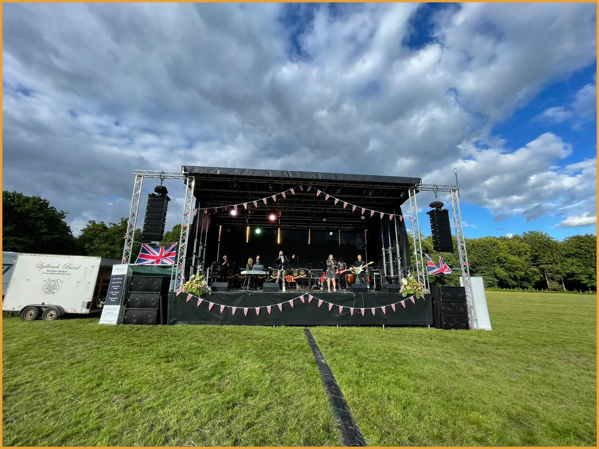 Martin Audio W8LM line array flown beside an outdoor stage