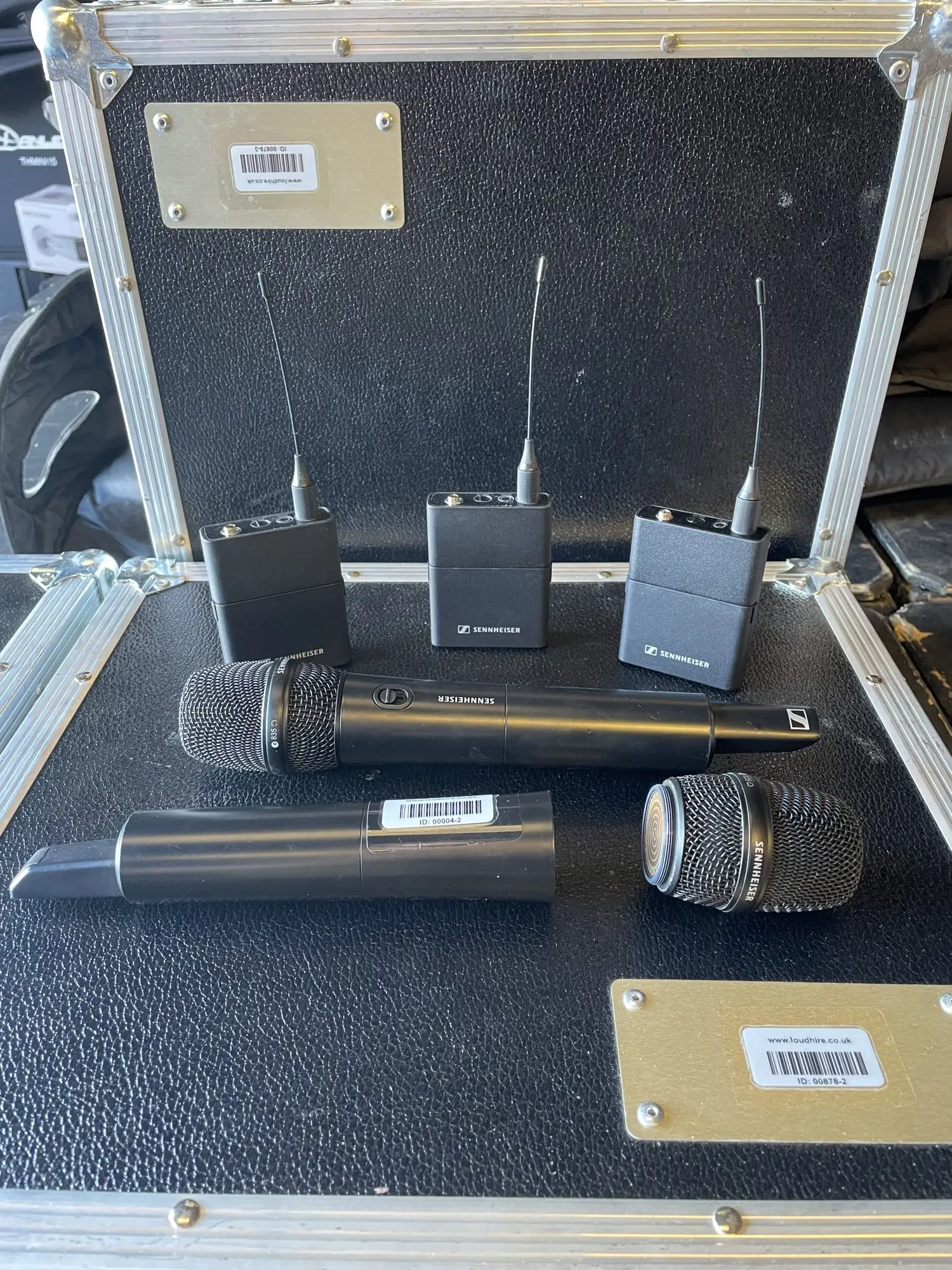 Selection of handheld and beltpack wireless microphones laid out