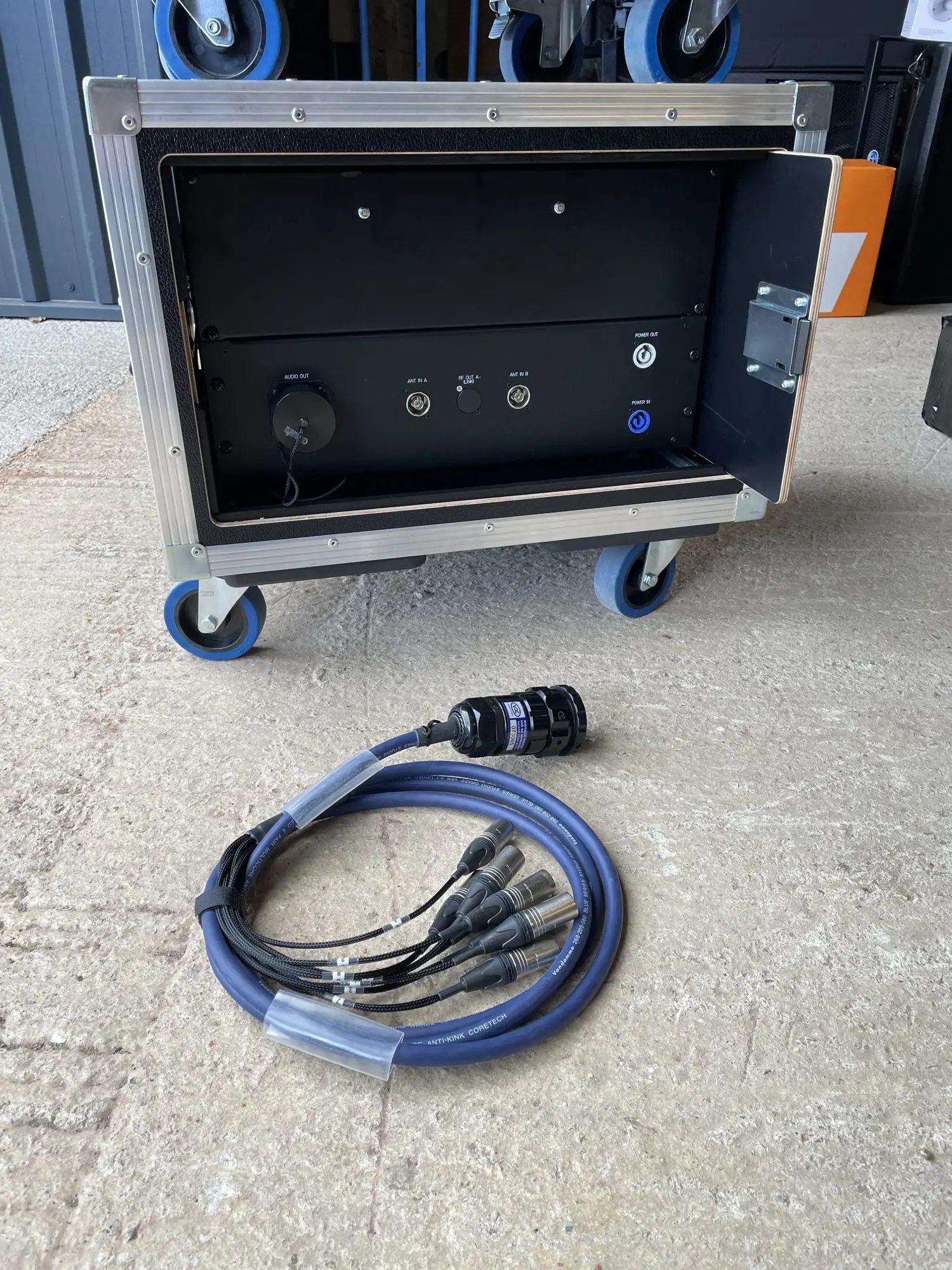 Rear patch panel of an eight-way wireless microphone rack with multipin output