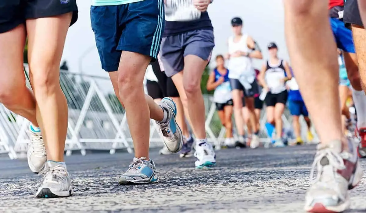 Runners' legs and trainers on a road during a mass-participation race