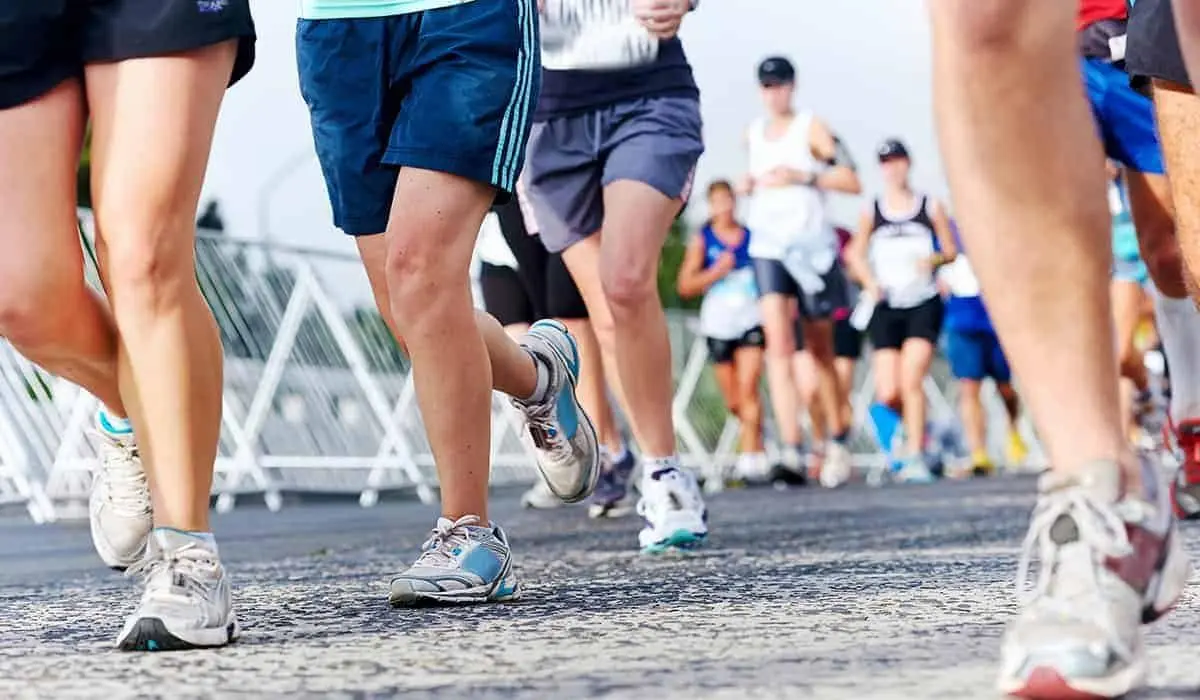 Runners' legs and trainers on a road during a mass-participation race