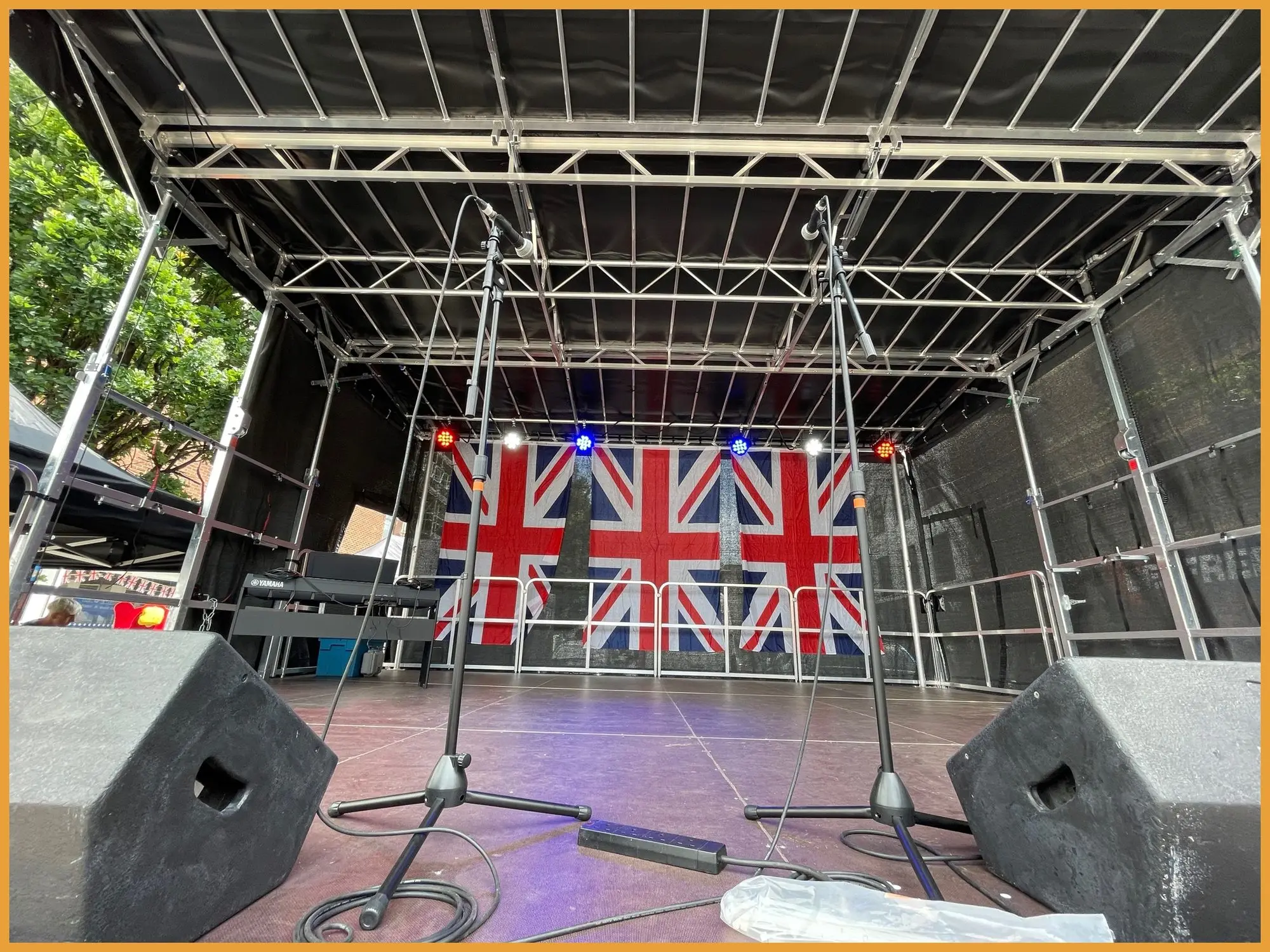 Stagemobil trailer stage dressed with Union Jack flags on Ilford high street