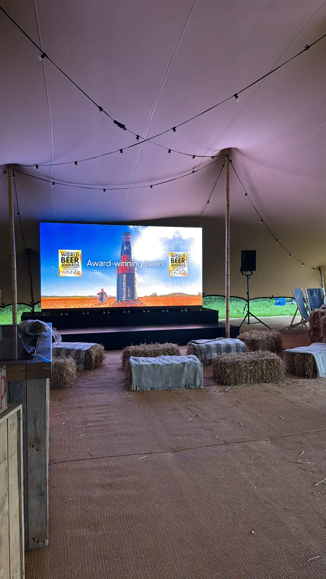 4m x 2m LED video wall inside a stretch tent with hay bale seating